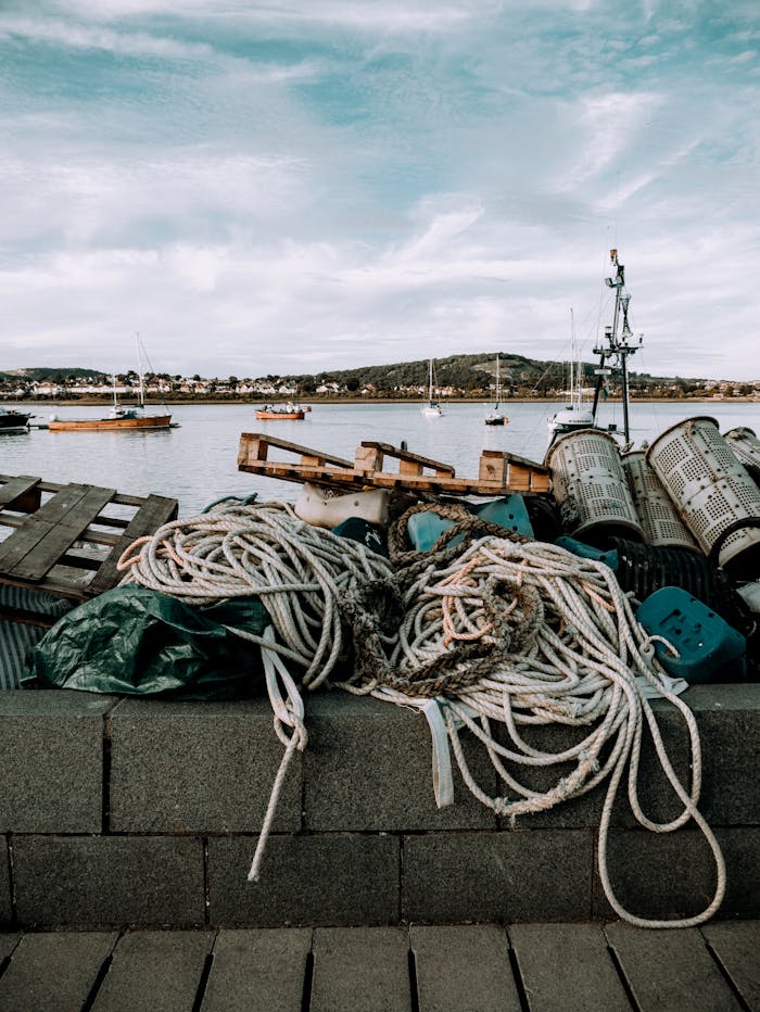 A scenic view of fishing equipment and boats by the seaside, perfect for maritime themes.